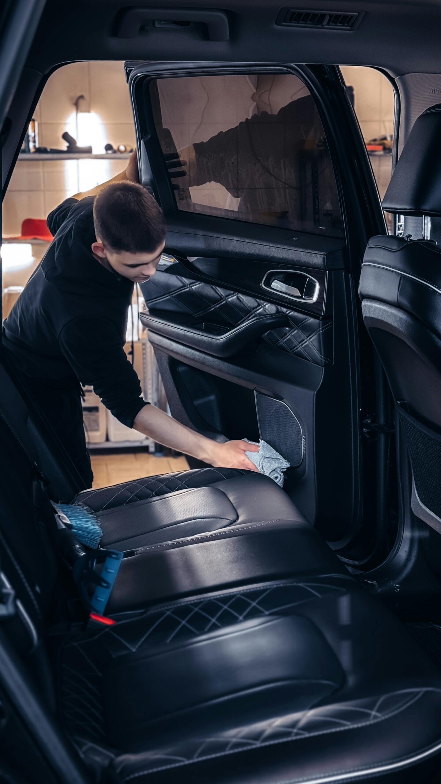 Professional car cleaning service in progress with focus on interior detailing for quality maintenance.